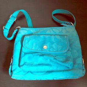 Medium size turquoise coach purse.